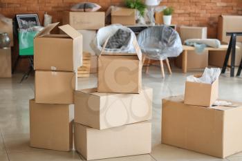 Carton boxes with belongings in room. Moving into new house�