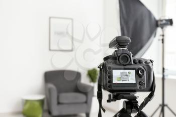 Professional camera on tripod in photo studio�