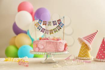 Stand with beautiful tasty birthday cake on table�