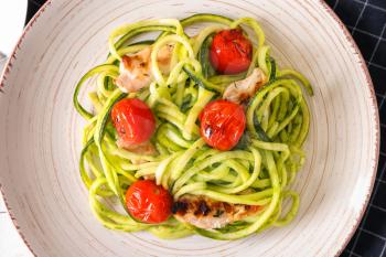 Zucchini spaghetti with tomatoes and meat on plate�