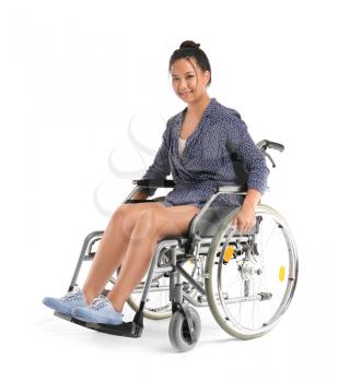 Asian woman in wheelchair on white background�