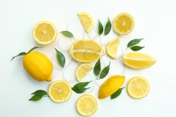 Flat lay composition with ripe juicy lemons on white background�