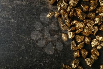 Gold nuggets on black background�