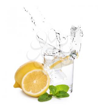 Glass of water with lemon and mint on white background�