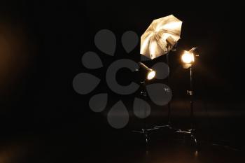 Professional lighting equipment on dark background�