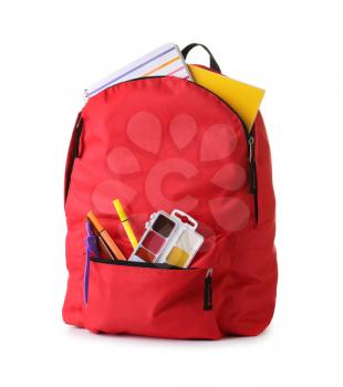 Backpack with school supplies on white background�