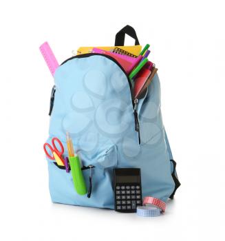 Backpack with school supplies on white background�