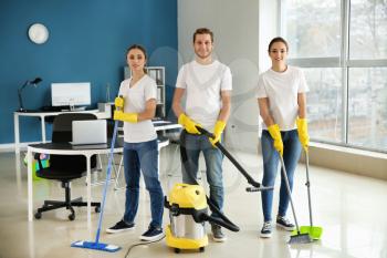 Team of janitors in office�