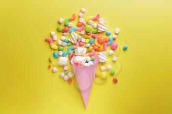 Composition with tasty sweets on color background�