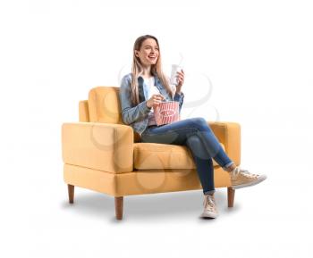 Young woman with popcorn watching movie on white background�