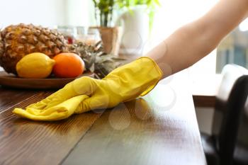 Young woman cleaning kitchen�