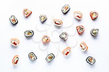 Tasty sushi rolls on white background�