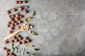 Macadamia nuts with oil on grey background�