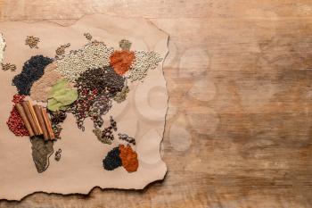 World map made of different spices on wooden background�