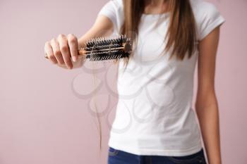 Woman with hair loss problem on color background�