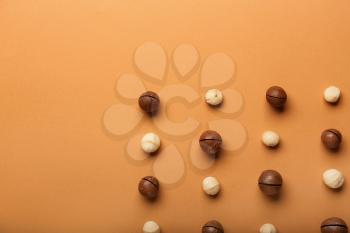 Many macadamia nuts on color background�