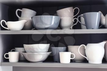 Shelves with clean dishes in kitchen�
