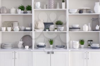 Open cupboard with clean dishes in kitchen�