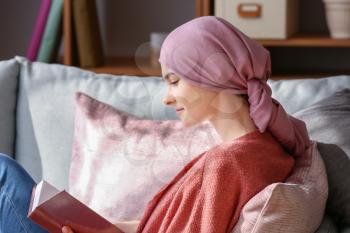 Woman after chemotherapy reading book at home�