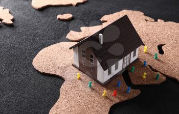 Model of house with pins on map. Concept of earthquake�
