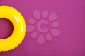 Bright inflatable ring on color background�
