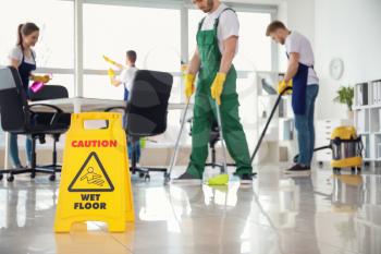 Sign board on floor in office during cleaning�