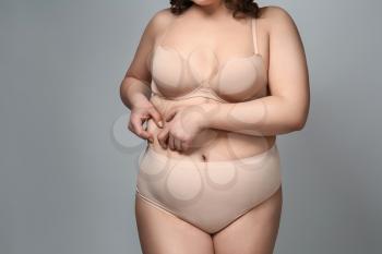 Overweight woman on grey background�
