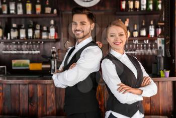 Young waiters in bar 