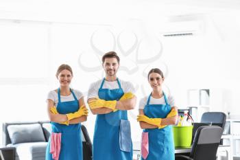 Team of janitors in office�