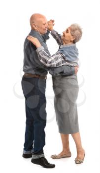 Portrait of dancing senior couple on white background�
