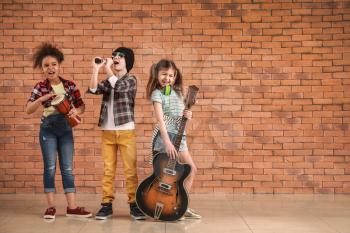 Band of little musicians against brick wall�
