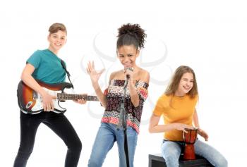 Teenage musicians playing against white background�