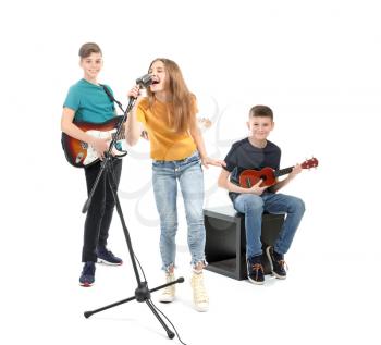 Teenage musicians playing against white background�