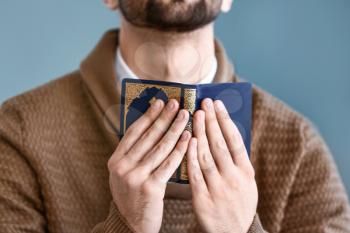 Young Muslim man praying indoors�