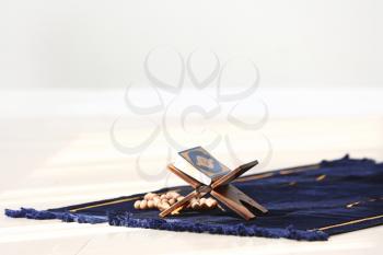 Koran and tasbih on Muslim prayer mat�