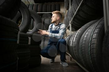 Male seller in car tire store�
