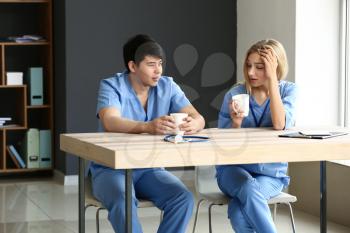 Young medical assistants having break during work in clinic�