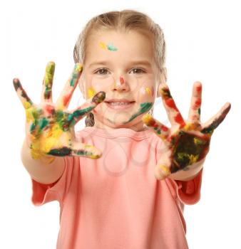 Funny little girl with hands and face in paint on white background�