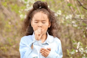 African-American girl having asthma attack outdoors on spring day�
