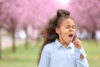 African-American girl having asthma attack outdoors on spring day�
