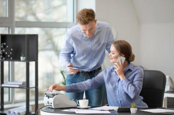 Male and female accountants working in office�