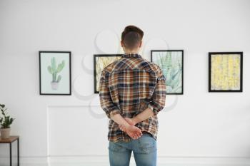 Man at exhibition in modern art gallery�