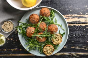 Plate with tasty falafel balls on wooden table�