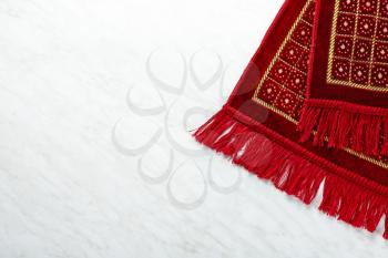 Muslim prayer rug on white background�