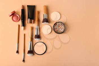 Set of cosmetics for contouring makeup on color background�