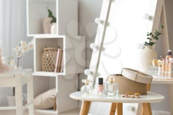 Table with accessories and cosmetics in modern makeup room�