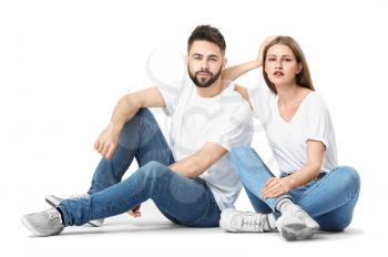 Stylish young couple in jeans on white background�