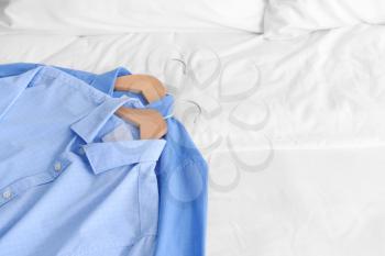 Clothes after dry-cleaning on bed�