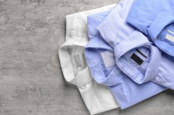 Shirts after dry-cleaning on wooden background�