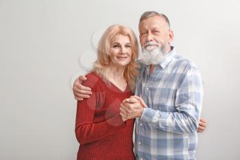 Portrait of mature couple on light background�